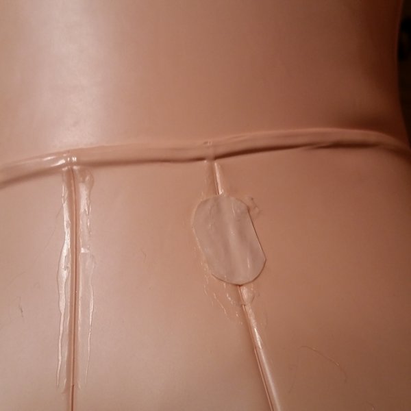 close up of prior seam failure repair on back of air doll