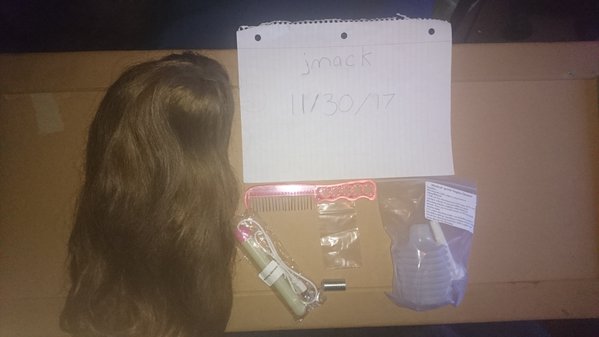 brunette wig, comb, unused vagina warmer, extra neck bolt, right pinky nail and left thumb nail in the small baggy, unused cleaner bottle