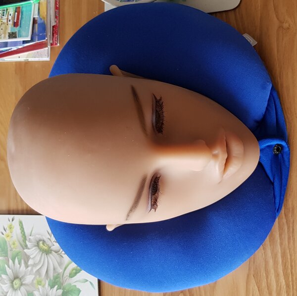 Detached head on airplane pillow