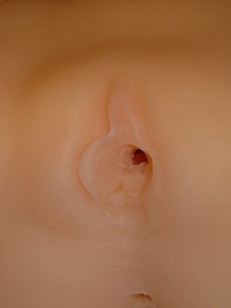 Depicts Lower bottom outside of vagina area is &quot;dug out&quot;, not smoothed, rugged. Missing right Labia section. Do you see any color?