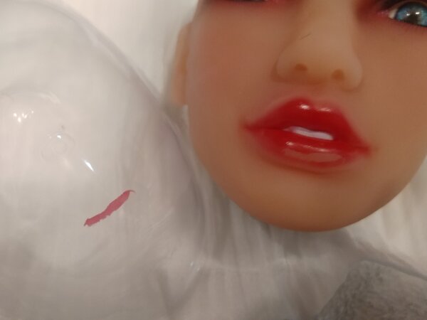 Detail of my doll's lip color transfer from head to the face shield.